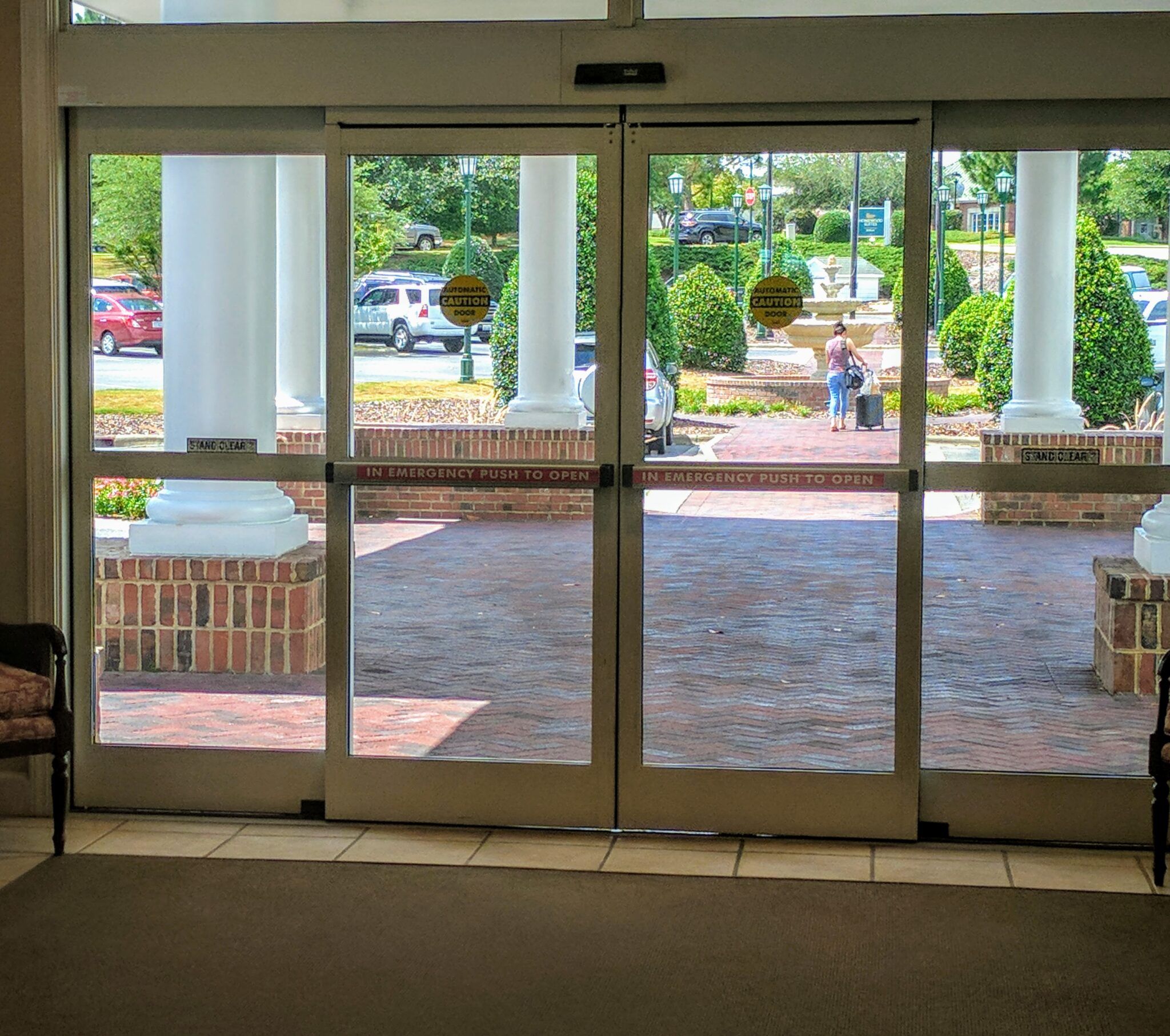 Automatic door with crash bars